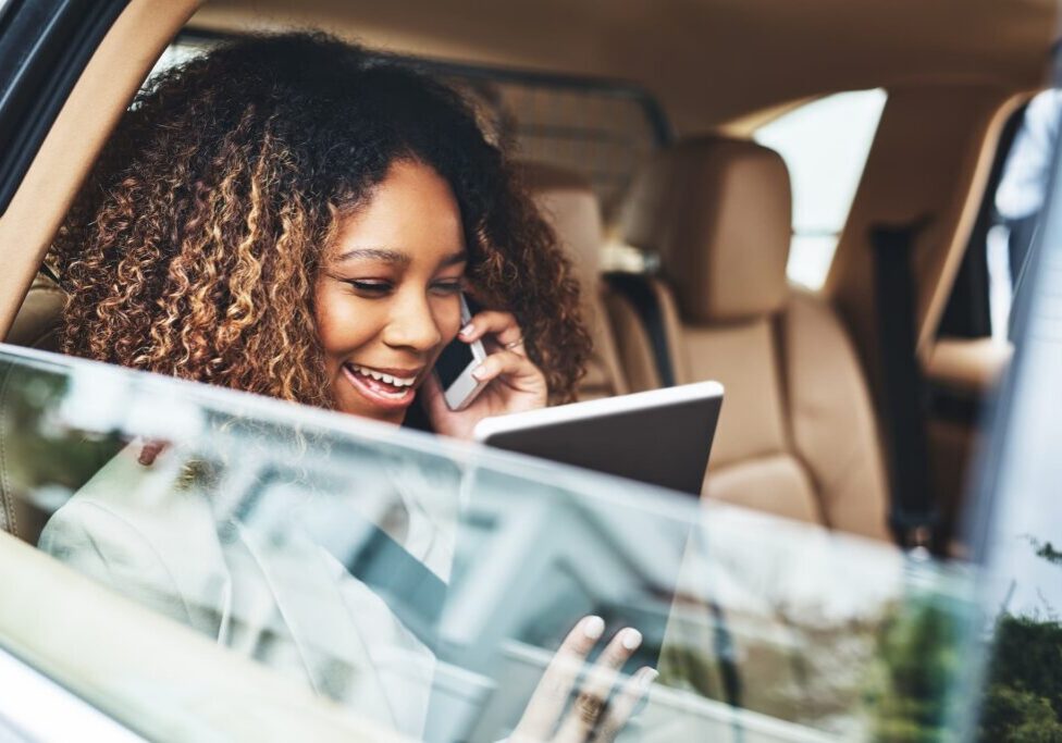 Woman in a car attending a meeting on an airport car service