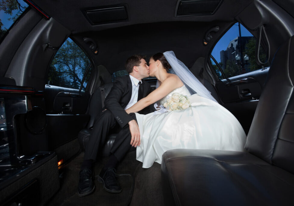 Married Couple Kissing inside a Wedding Limo